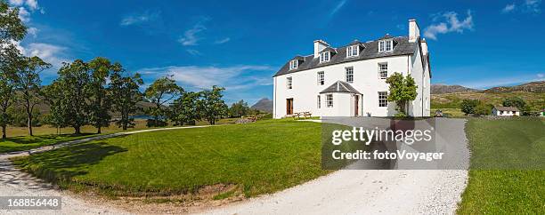white country house with green lawn in picturesque rural location - scottish highlands cottage stock pictures, royalty-free photos & images