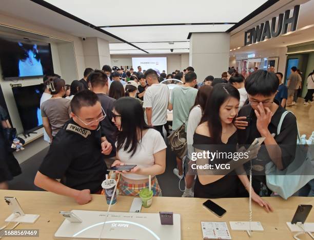 Customers try out Mate 60 series and Mate X5 series smartphones at a Huawei store on September 17, 2023 in Nanjing, Jiangsu Province of China.