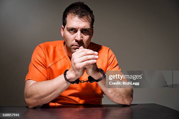 police interrogation room - prison jumpsuit stock pictures, royalty-free photos & images