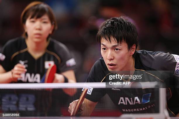 Japan's Misako Wakamiya and Kenji Matsudaira , plays against Romania's Ovidiu Ionescu and Bernadette Szocs, on May 16, 2013 in Paris, during the...