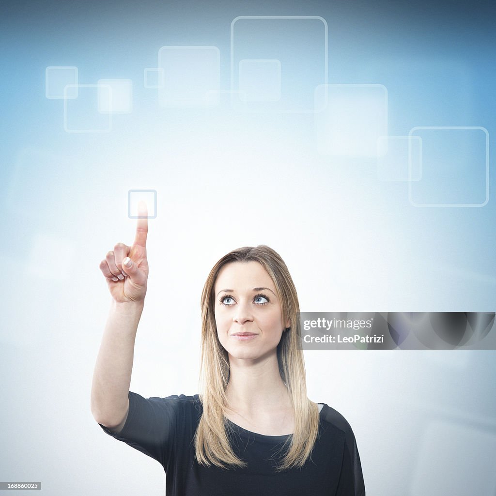 Young woman touching a futuristic screen
