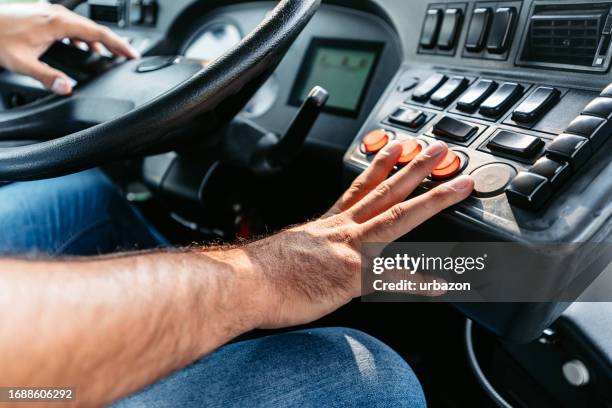 mid adult man driving a bus on the street - bus driver stock pictures, royalty-free photos & images