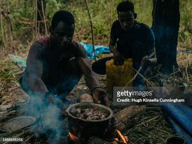 Idriss and Karim, two members of a nomadic group from Chad prepare a meal of boiled sheep meat on September 20, 2023 in Niangara, Congo. Tensions...