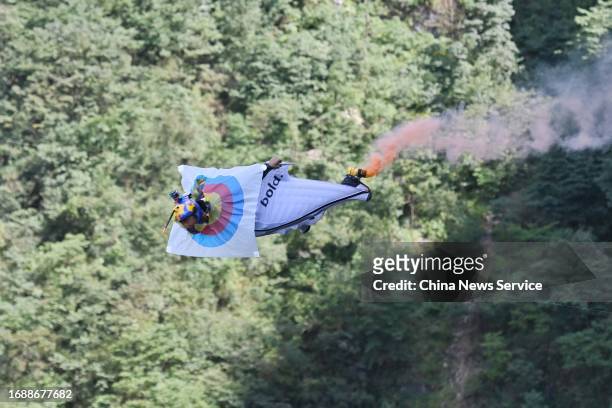 Wingsuiter Zhang Shupeng of China hits the target as he competes in the precision fly-through competition during the ninth World Wingsuit League...