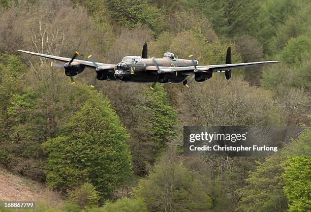 Lancaster bomber flies over Ladybower reservoir in the Derbyshire Peak District to mark the 70th anniversary of the World War II Dambusters mission...