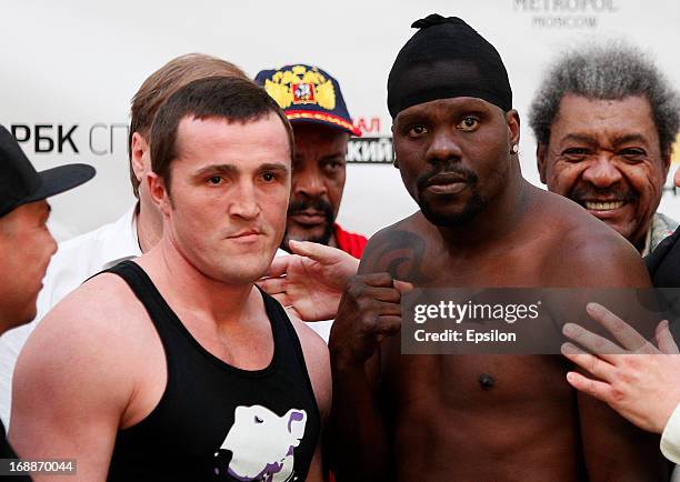 Denis Lebedev of Russia and Guillermo Jones of Panama as promoter Don King pose during the official weigh-in for their WBA cruiserweight title bout...