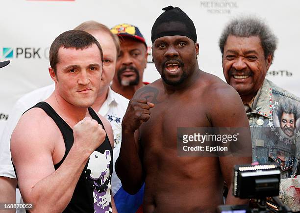 Denis Lebedev of Lebedev and Guillermo Jones of Panama pose as promoter Don King looks on during the official weigh-in for their WBA cruiserweight...