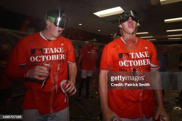 Heston Kjerstad and Jacob Webb of the Baltimore Orioles celebrate in the clubhouse after the Baltimore Orioles clinched a 2023 MLB playoff berth...