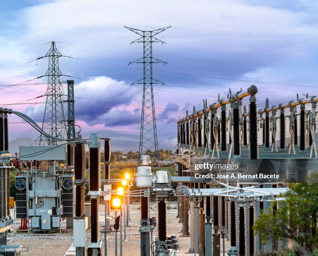 General view of a power distribution power plant at sunset.
