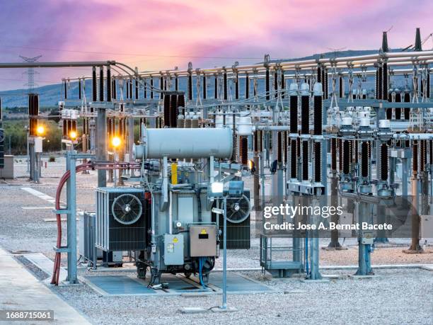 general view of a power distribution power plant at sunset. - gerador imagens e fotografias de stock