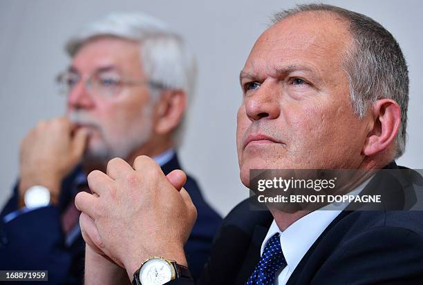 Deputy Plan Commissioner Jan Verschooten with Plan Commissioner Henri Bogaert look on during a press conference by the Central Economic Council /...