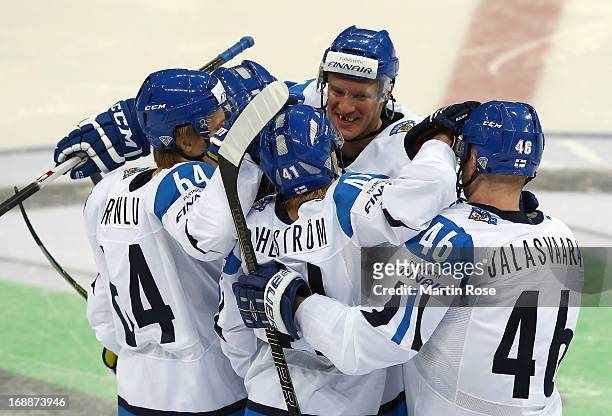 Ossi Vaananen of Finland celebrate with his team mates their opening goal during the IIHF World Championship quarterfinal match between Finland and...