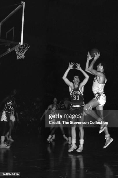 Jack Twyman of the Cincinnati Royals defends against Dolph Schayes of the Syracuse Nationals during a game played circa 1962 at the Onondaga War...