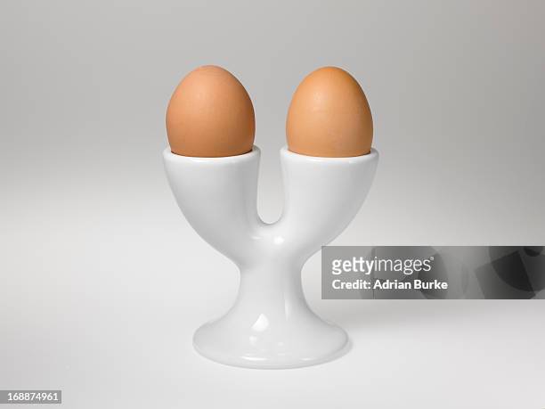 two boiled eggs. - eierbecher stock-fotos und bilder