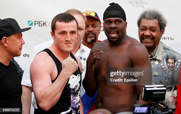 Denis Lebedev of Russia and Guillermo Jones of Panama pose during the official weigh-in for their WBA cruiserweight title bout at the Entertainment...