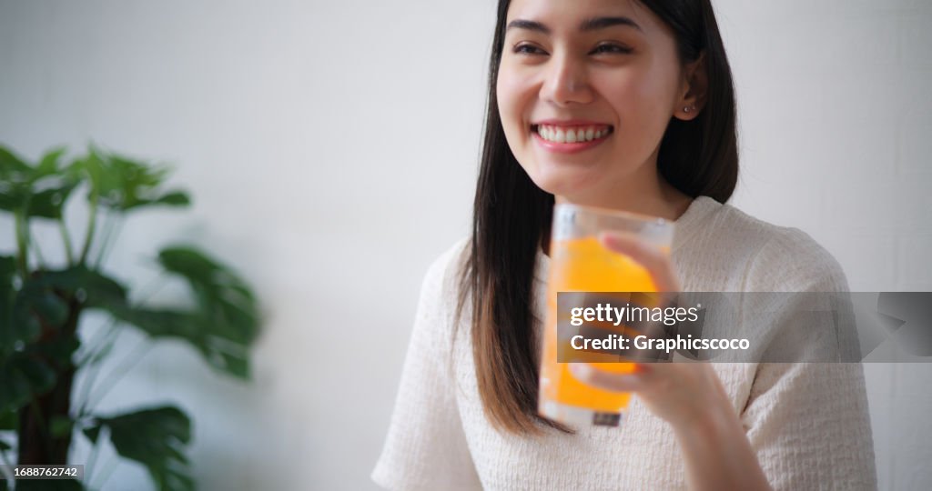 Young beautiful woman and friends having fun celebrating together at home