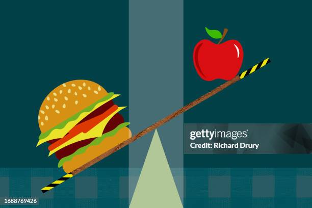 a burger and an apple on a seesaw - food and drink icon stock pictures, royalty-free photos & images