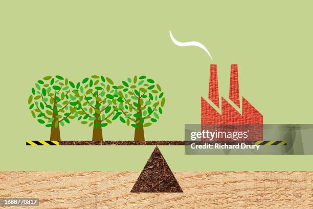 three trees and a factory balanced on a seesaw - emissioni di co2 foto e immagini stock