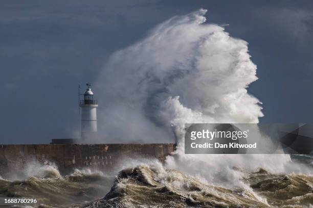 Storm waves batter the Newhaven breakwater and Lighthouse on September 18, 2023 in Newhaven, United Kingdom. Parts of England are experiencing heavy...