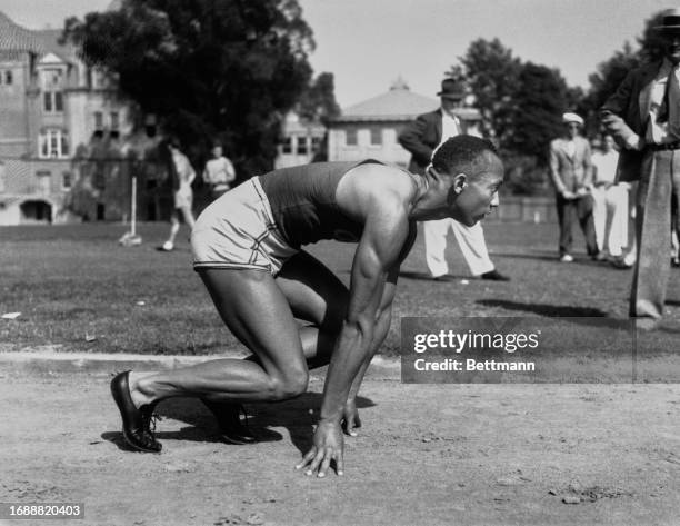 American track and field athlete Jesse Owens getting ready to run a 100 yard sprint, June 18th 1935.