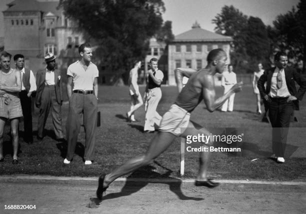 American track and field athlete Jesse Owens running a 100 yard sprint, June 18th 1935.