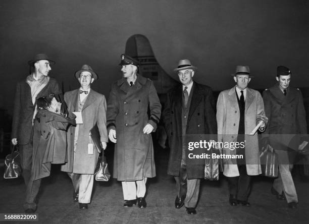 An group of scientists including nuclear physicist J Robert Oppenheimer arriving at Orly Field airport in Paris, France, December 5th 1951. They are...