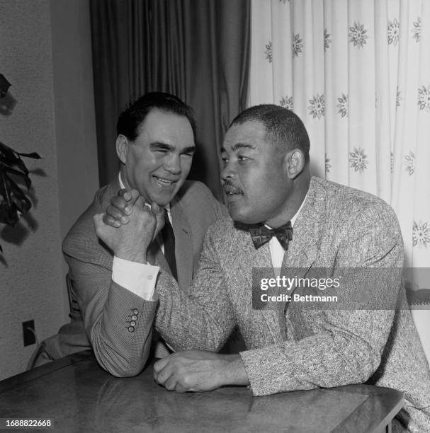 Former World Heavyweight Champions Max Schmeling of Germany and Joe Louis of the United States arm wrestling during a reunion in Miami Beach,...