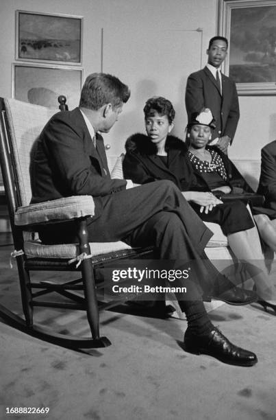 President John F Kennedy sitting in his rocking chair and talking with athlete Wilma Rudolph at the White House in Washington, April 14th 1961....