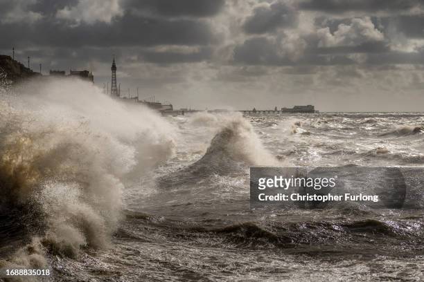 Strong winds and a high tide create large waves that hit the seawall on Blackpool Promenade on September 18, 2023 in Blackpool, United Kingdom. Parts...
