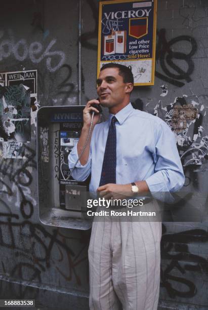 Businessman Andre Balazs uses a payphone, USA, circa 1995.