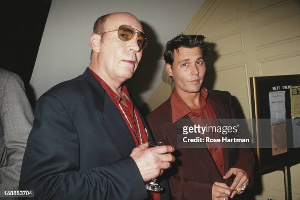 American author and journalist Hunter S. Thompson and actor Johnny Depp attend a book party at the Players Club in New York City, 1997.
