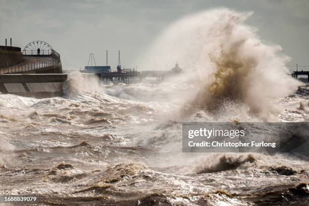 Strong winds and a high tide create large waves that hit the seawall on Blackpool Promenade on September 18, 2023 in Blackpool, United Kingdom. Parts...