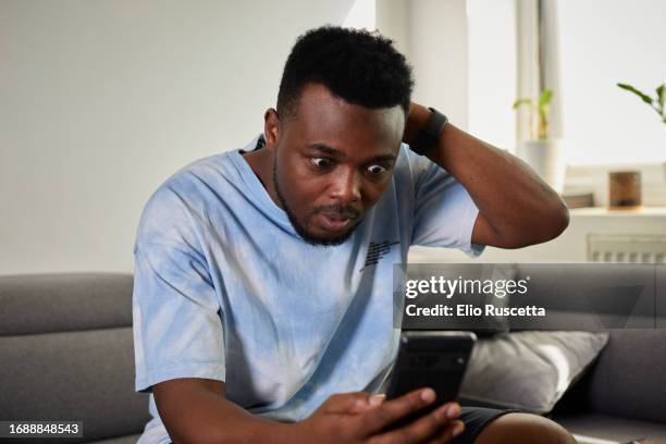 man shocked getting scammed on internet - scam victim stock pictures, royalty-free photos & images