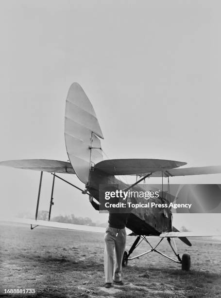 Valerie Mindelsohn wheeling out an aeroplane ready for Civil Air Guard training, September 1938.