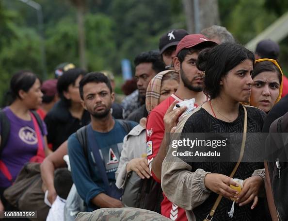 Random Immigrant Irregular immigrants wait in line at the border as the number of ...