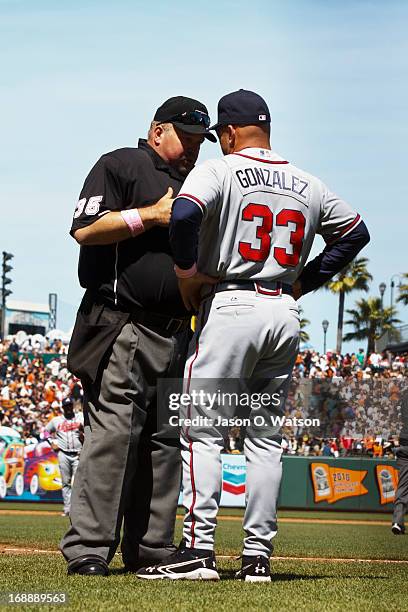 Fredi Gonzalez of the Atlanta Braves argues a call with umpire Wally Bell during the sixth inning against the San Francisco Giants at AT&T Park on...