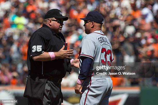 Fredi Gonzalez of the Atlanta Braves argues a call with umpire Wally Bell during the sixth inning against the San Francisco Giants at AT&T Park on...