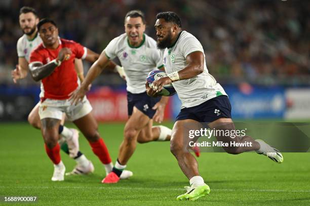 Bundee Aki of Ireland breaks through to score his 2nd try during the Rugby World Cup France 2023 match between Ireland and Tonga at Stade de la...