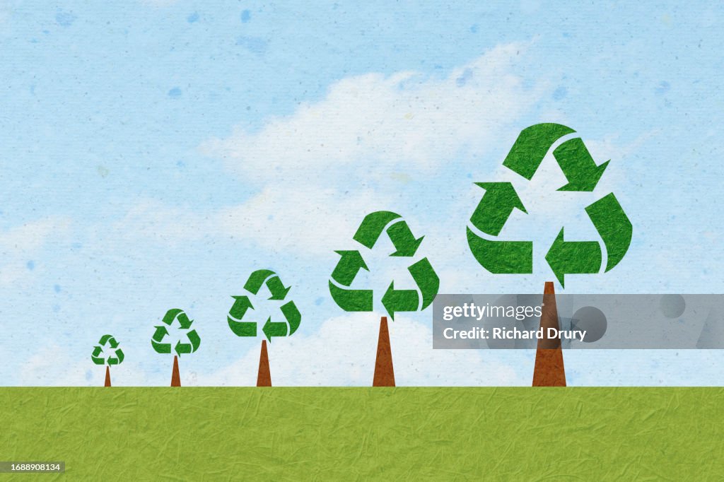 Growing trees made of recycling symbols