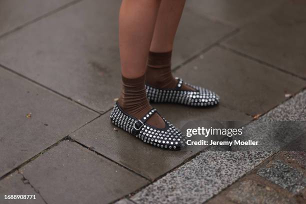 Fashion Week Guest was seen wearing alaia ballerinas with lots of silver diamonds and ornaments on it before Holzweiler Fashion Show during London...