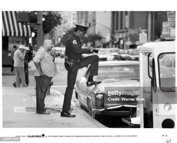 Bubba Smith writes a ticket in a scene from the film 'Police Academy 2: Their First Assignment', 1985.
