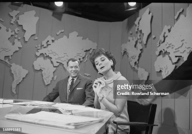 American broadcast journalists Hugh Downs and Barbara Walters talk on the 'Today' show set, New York, New York, 1966.