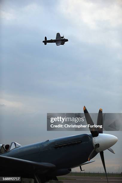 Lancaster Bomber 'The City of Lincoln' flys over a WWII Spitfire as they take part in a Sunset Ceremony to mark the 70th anniversary of the World War...