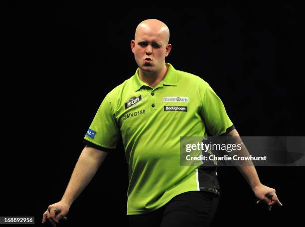 Michael Van Gerwen of Holland winces after going close during his semi final match against James Wades of England during the McCoy's Premier League...