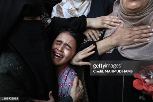 Mourners react during the funeral of Palestinian Majdi Ghabayen, who died of wounds sustained in an explosion during a rally near the border fence...