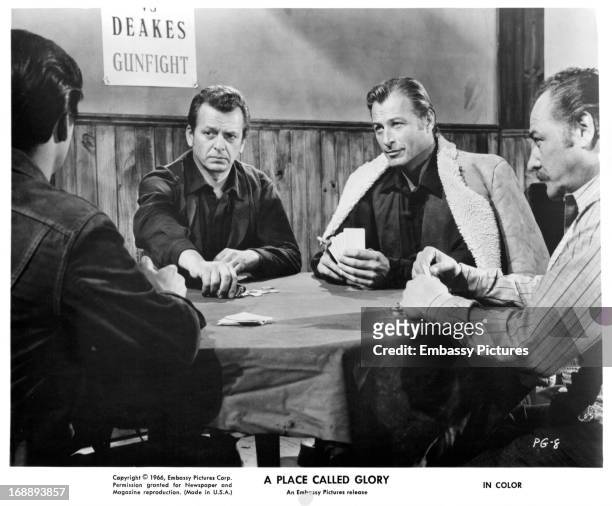 Pierre Brice, Lex Barker and others play cards in a scene from the film 'A Place Called Glory', 1965.