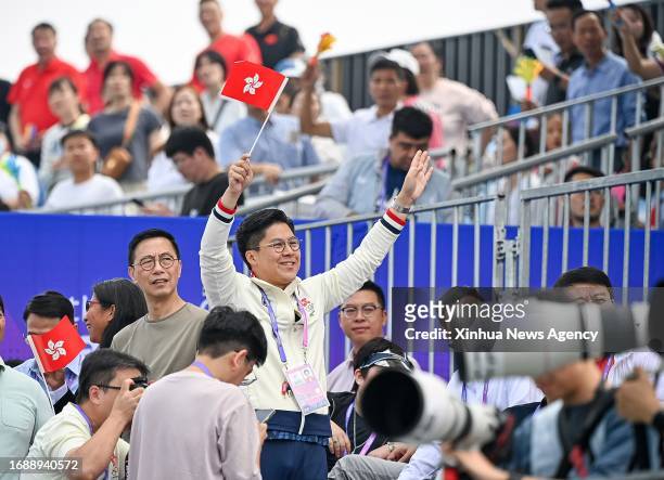 Kenneth Fok Kai-kong from delegation of China's Hong Kong waves to spectators during the men's pair final of rowing at the 19th Asian Games in...