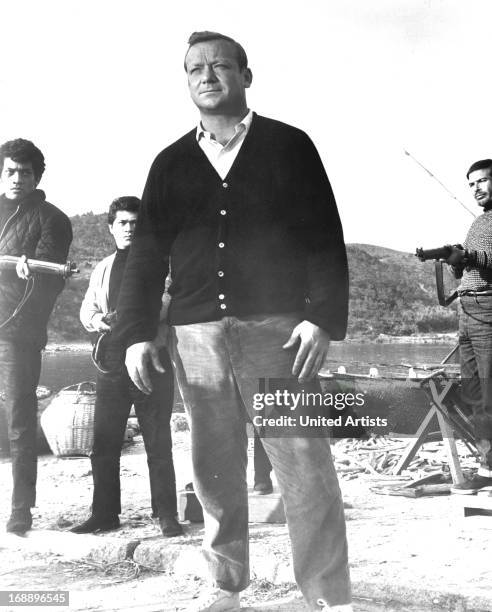 Aldo Ray holds is surrounded in a scene from the film 'Kill A Dragon', 1967.