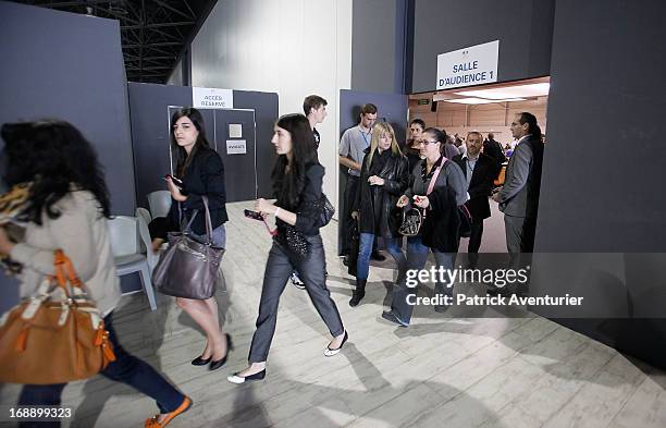 Women who received PIP breast implants walk inside the courthouse with their lawyers at Parc Chanot on May 16, 2013 in Marseille, France. Jean-Claude...