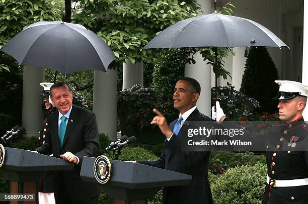 Two U.S. Marines hold umbrellas over U.S. President Barack Obama and Prime Minister Recep Tayyip Erdogan of Turkey as they speak to the media in the...